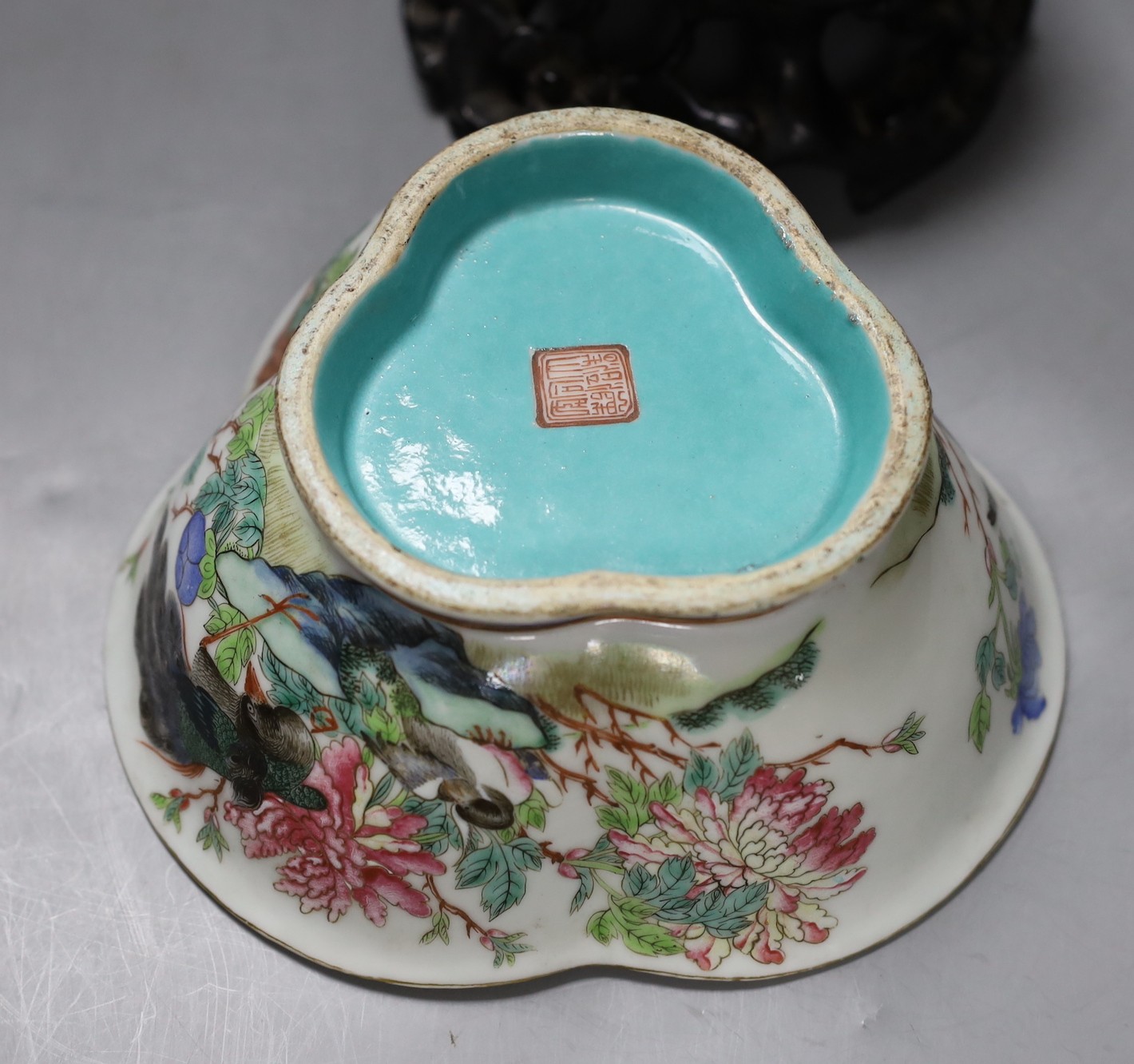 A Chinese Tongzhi famille rose dish with floral and bird decoration on carved stand, 14cm tall overall